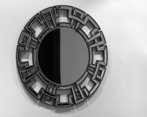 ornate mirror on a white wall
