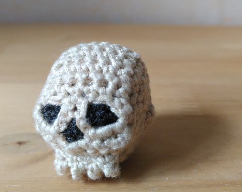 1st of November: Crochet slull made from white wool. The eye sockets are made from black wool.